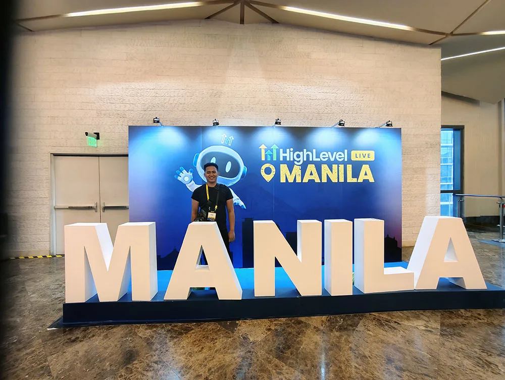 Lemuel Duyag in front of the HighLevel LIVE Manila signage