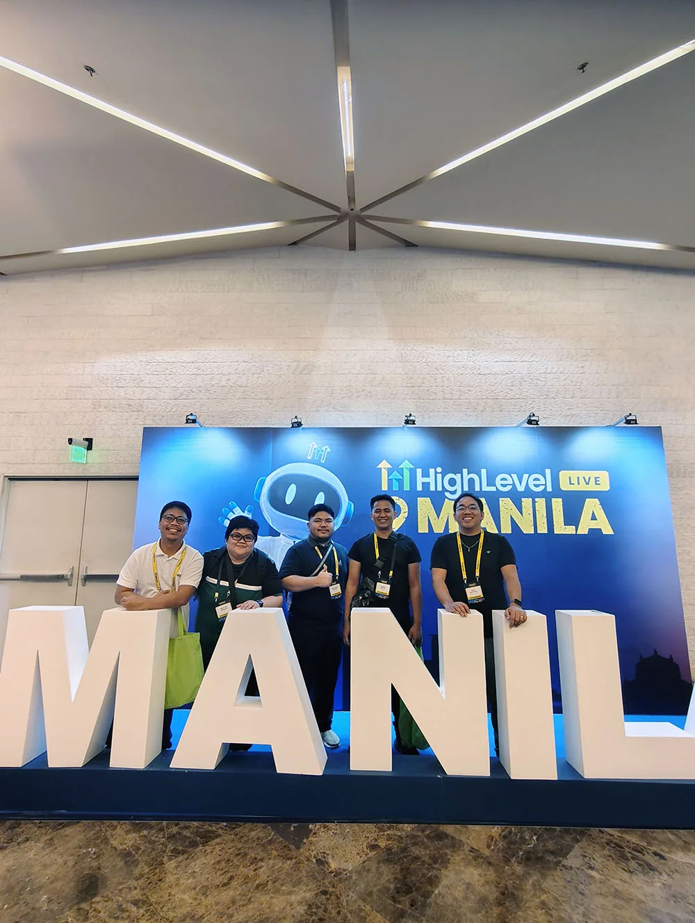 Five attendees at the HighLevel LIVE Manila photo wall